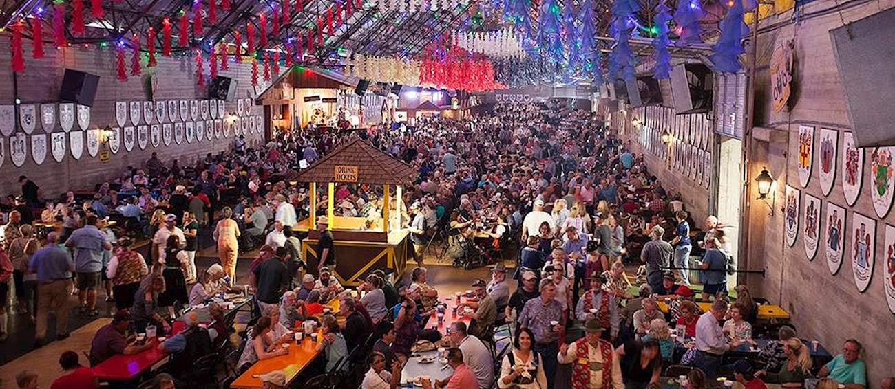 Wurstfest in New Braunfels, Texas at Landa Park — packed festival hall with crowds, live music, and German beer, a popular fall outing for wedding guests staying at Willow Sky Ranch Hill Country wedding venue
